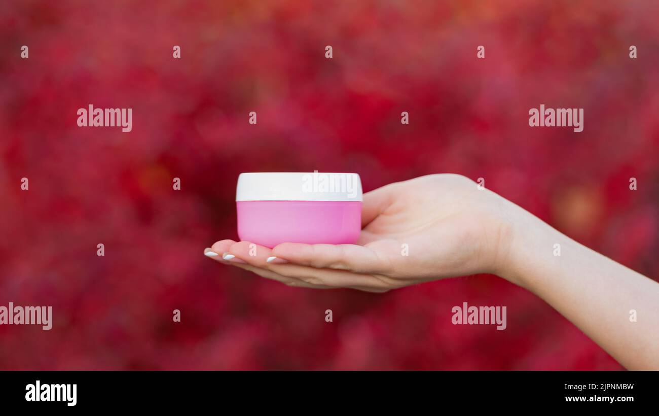 Hände halten Creme oder Lotion Glas für die Hautpflege Stockfoto