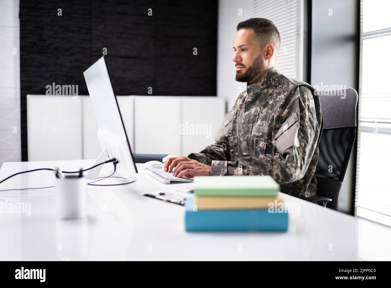 Ausbildung Von Militärstudentin. Armeesoldat Veteran Mit Computer Stockfoto