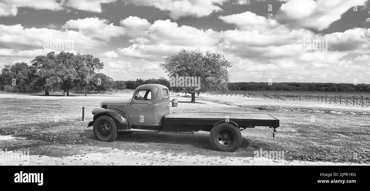 Fredericksburg, Texas – 12-2020 November Slate Mill Wine Collective Winery in Texas Hill Country mit 1942 GMC-Wein-Truck und Weinbergen im Hintergrund. Stockfoto