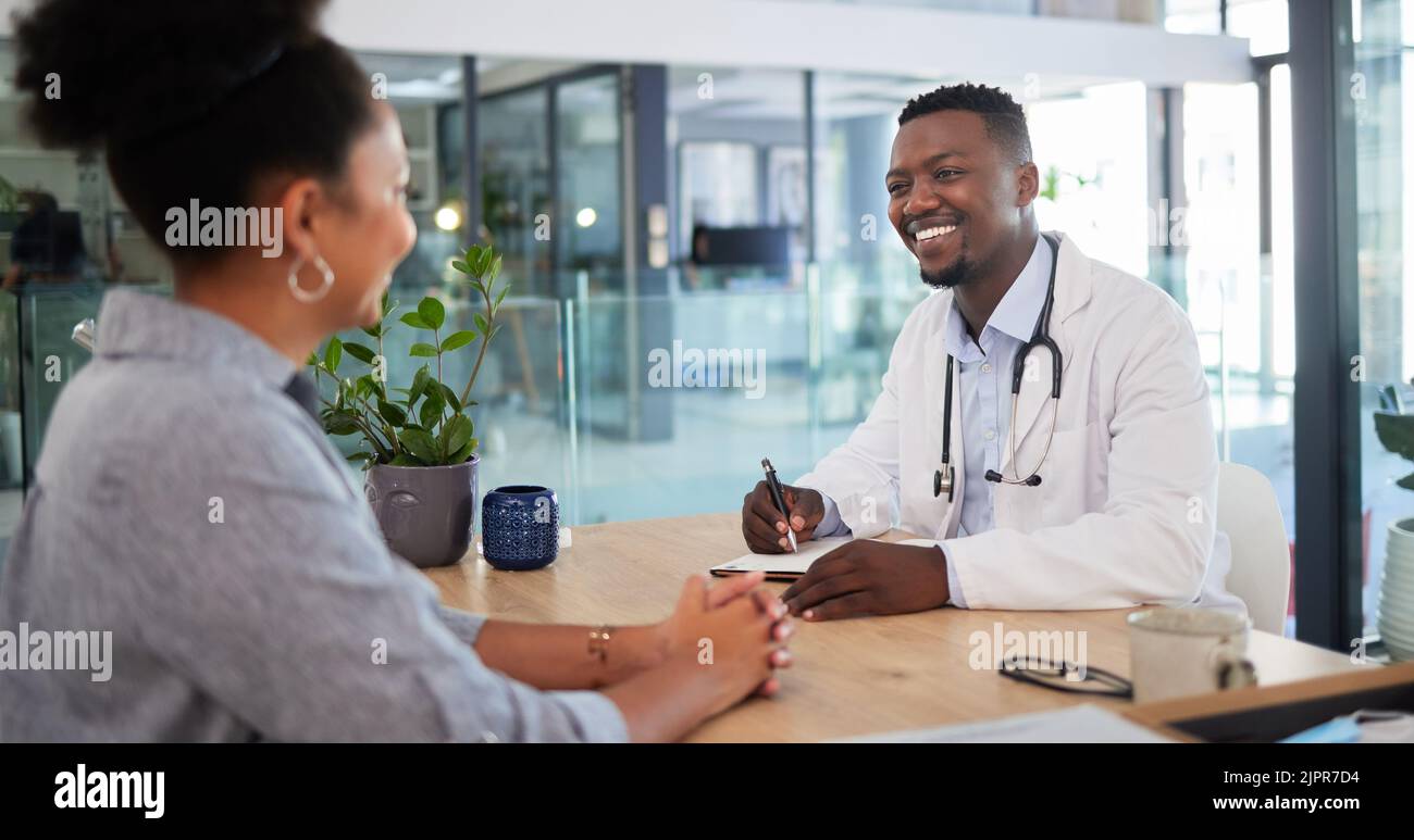 Ärzte Ernennung einer Patientin, die einen Arzt in einem Krankenhausbüro konsultiert. Glücklich arbeitende Ärzte und Gesundheitsarbeiter arbeiten mit einem Lächeln im Gespräch Stockfoto