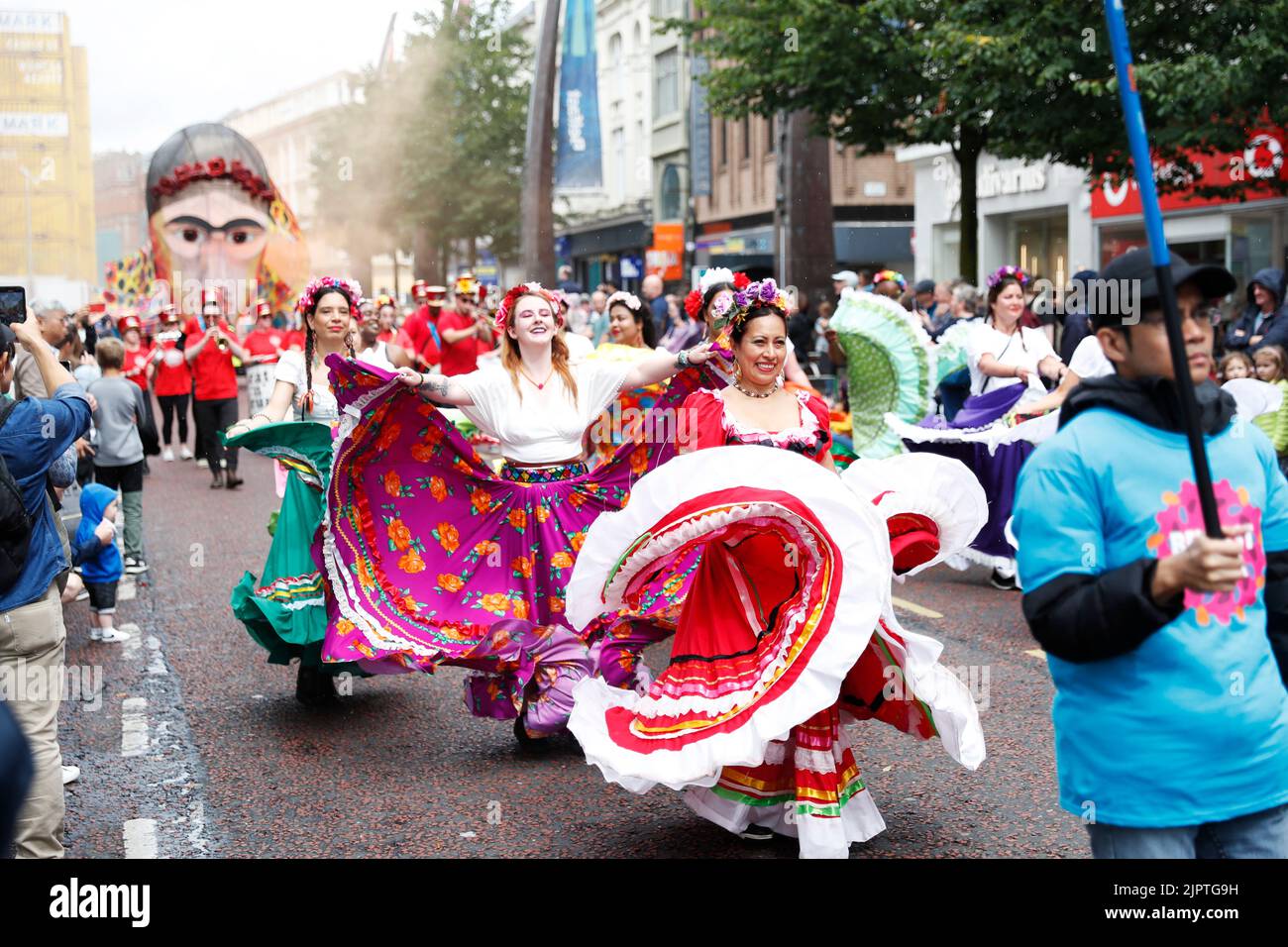 Die Menschen säumen die Straßen, während der Mela Carnival durch das Stadtzentrum von Belfast zieht. Bilddatum: Samstag, 20. August 2022. Stockfoto