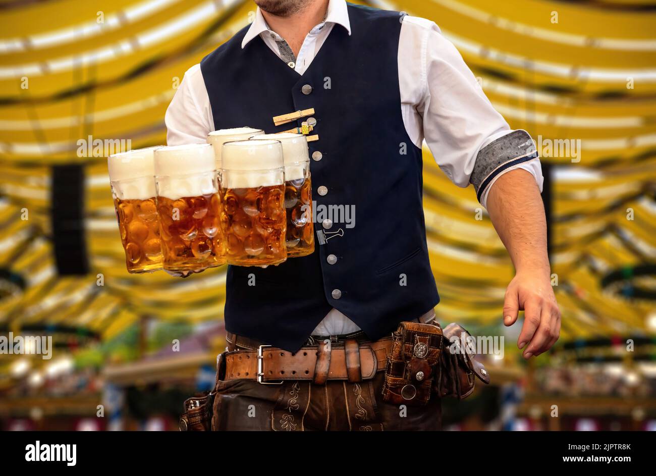 Oktoberfest, München. Kellner in traditioneller bayerischer Tracht serviert Bier, Nahaufnahme. Oktober Fest Deutsches Bierfest. Stockfoto