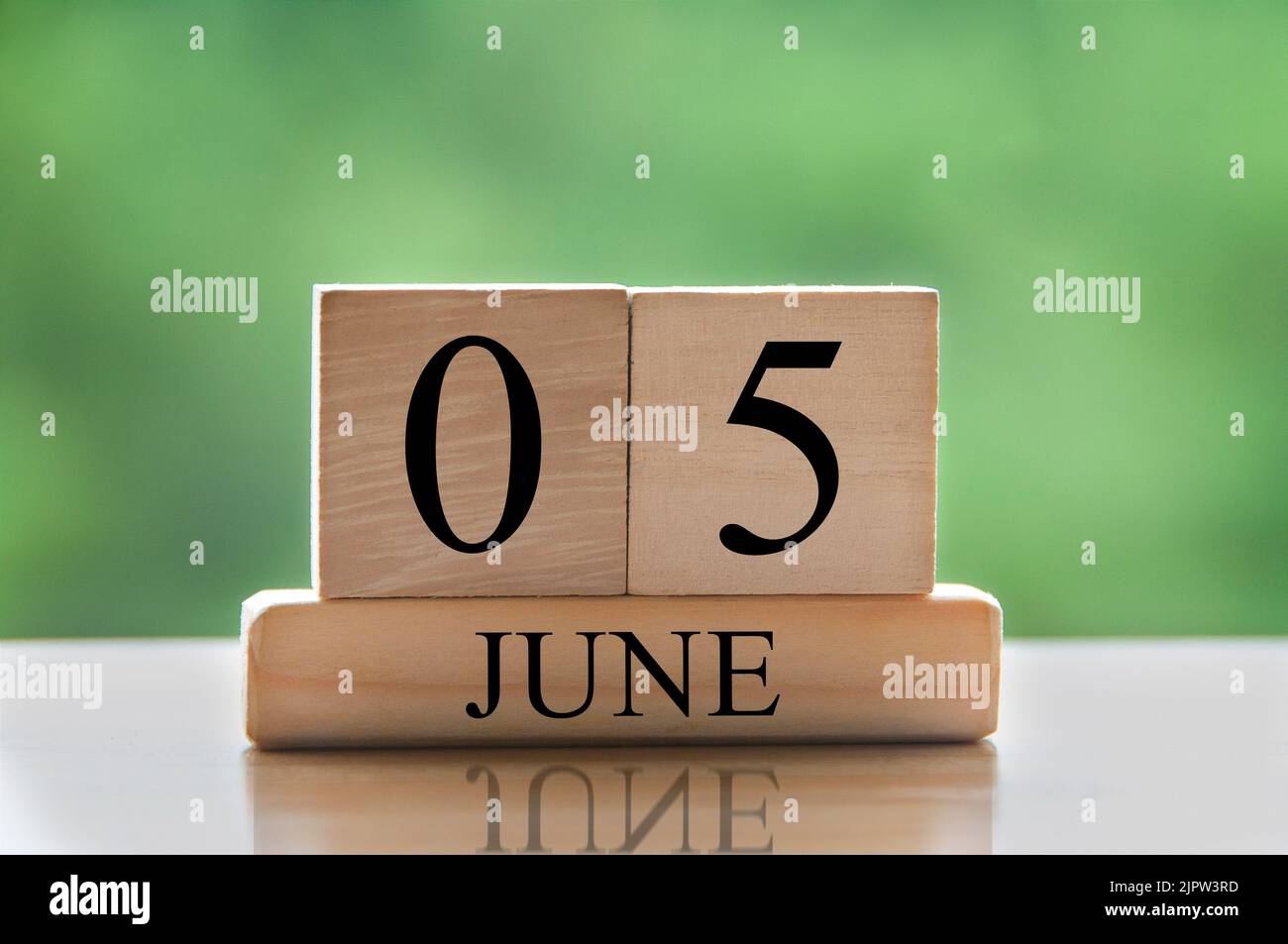 Kalenderdatentext Juni 5 auf Holzblöcken mit verschwommenem Naturhintergrund. Raum und Kalenderkonzept kopieren. Stockfoto