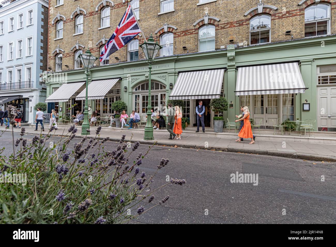 Menschen, die am Eingang des Charlotte Street Hotels in der Charlotte Street, Fitzrovia, London W1, vorbeigehen Stockfoto