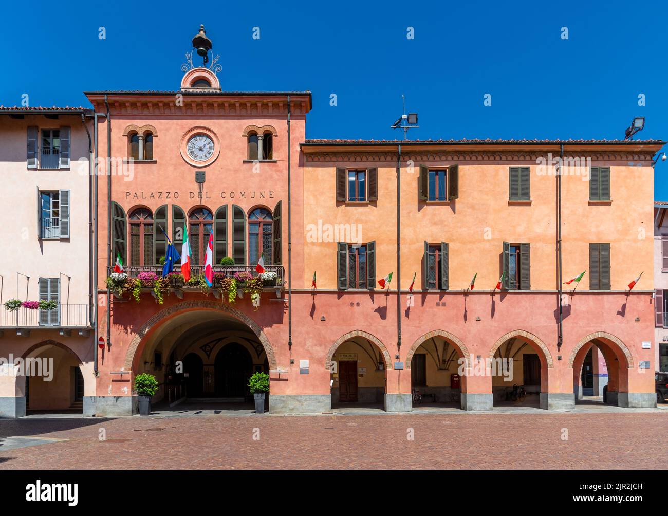 Alba, Langhe, Piemont, Italien - 16. August 2022: Das Rathaus von Alba mit den blühenden Balkonen und der italienischen Nationalflagge Stockfoto