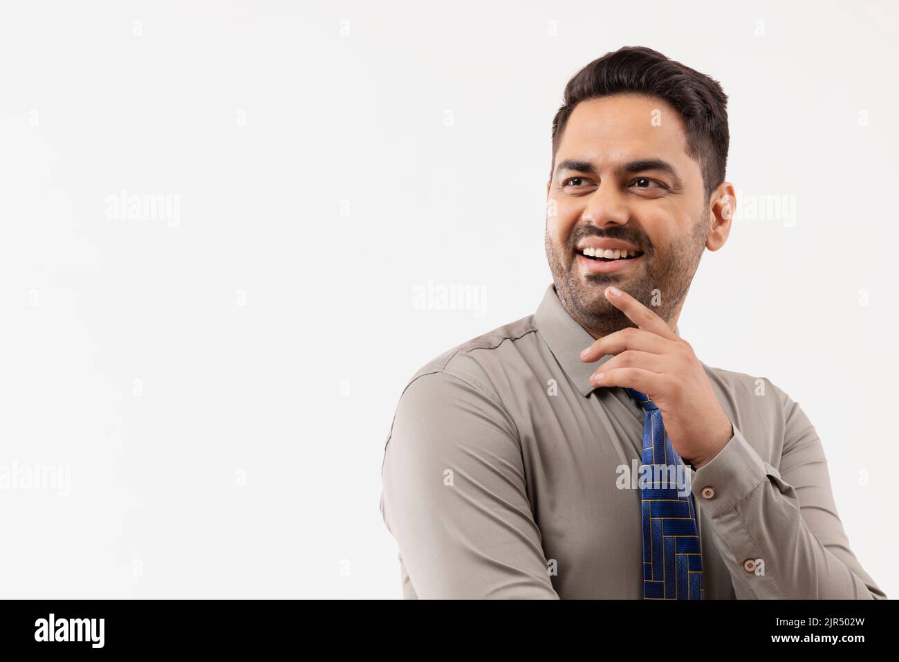 Porträt eines fröhlichen jungen Geschäftsmannes, der sich anderswo umsieht Stockfoto