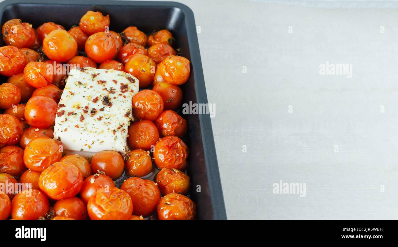 Der Prozess der Herstellung von Feta-Pasta. Gebackener Käse und Tomaten ...