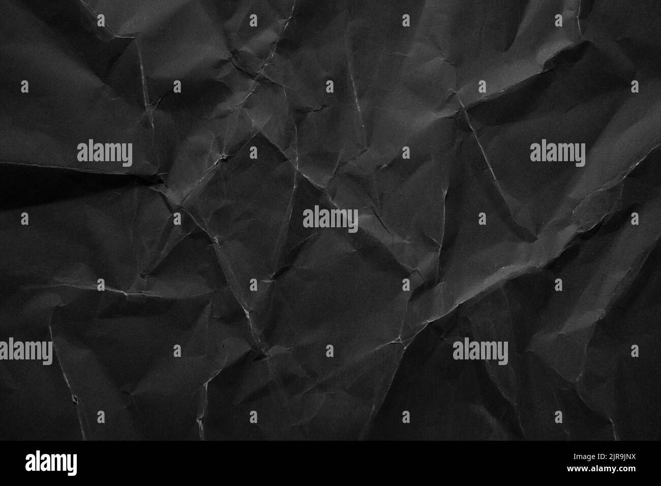 Schwerer zerknittert schwarzer Papier Textur Hintergrund Stockfoto