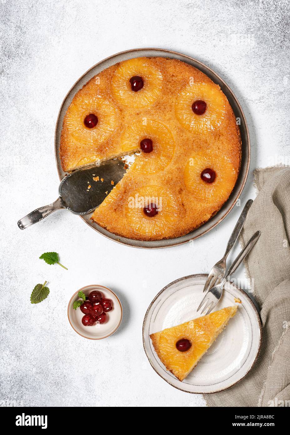 Stück umgedrehter Ananaskuchen mit kandierten Kirschen und Karamell. Hausgemachtes tropisches Dessert im Sommer. Draufsicht. Stockfoto