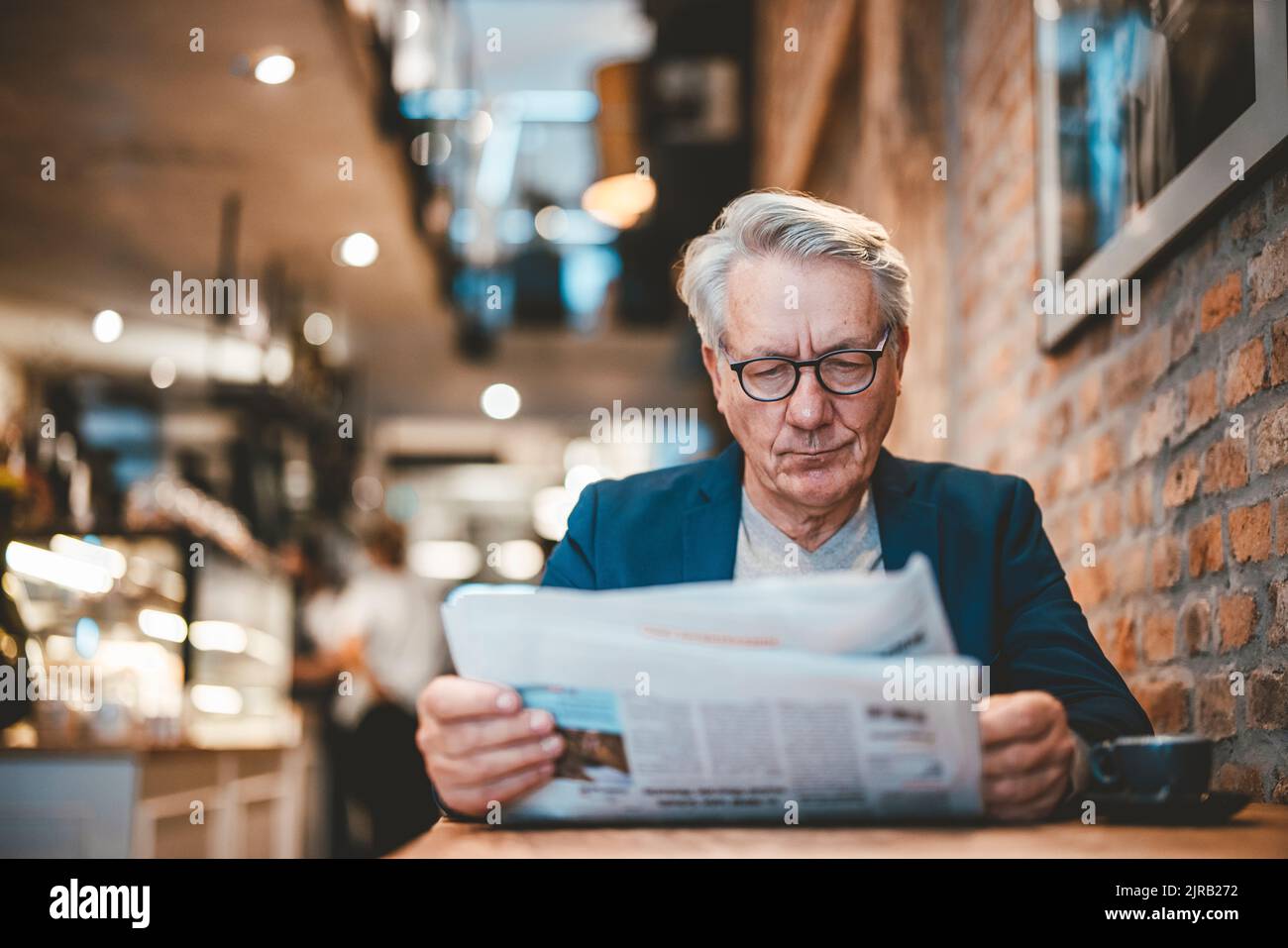 Geschäftsmann lesen Zeitung im café Stockfoto