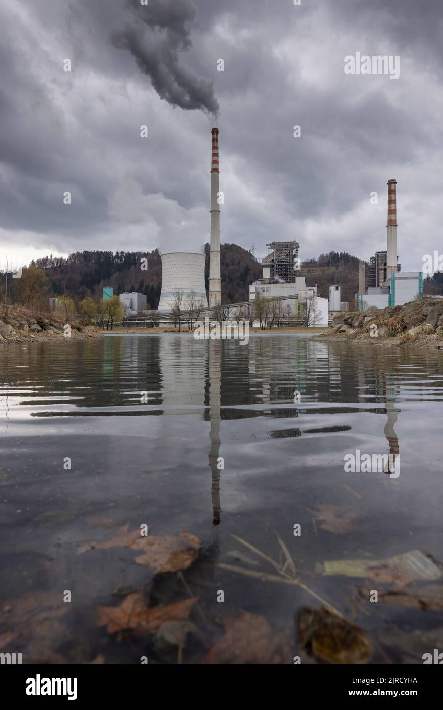 Der schwere graue Himmel über dem thermischen Kraftwerk raucht Rauch und Smog aus und verbrennt Kohle, die die Luft verschmutzt Stockfoto