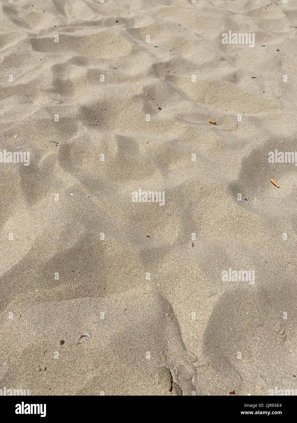 Goldener Sand Strand Textur Hintergrund an einem sonnigen Tag Stockfoto Goldener Sand Strand Textur Hintergrund an einem sonnigen Tag Stockfoto
