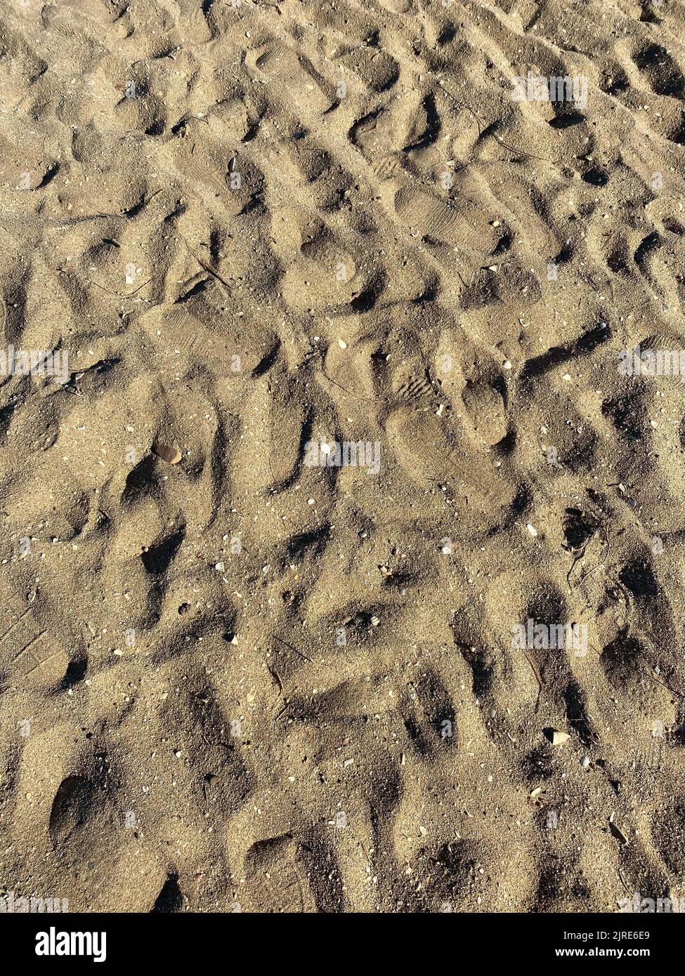 Goldener Sand Strand Textur Hintergrund an einem sonnigen Tag Stockfoto Goldener Sand Strand Textur Hintergrund an einem sonnigen Tag Stockfoto