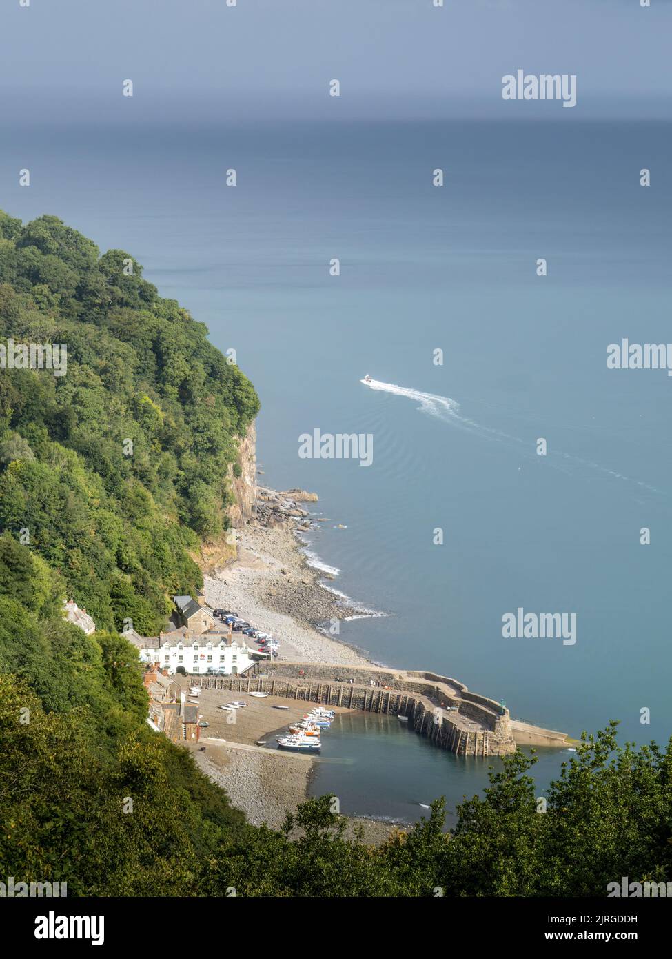 Clovelly, North Devon, UK - August 20 2022: Von den Klippen aus hat man einen Blick auf den Hafen, mit dem Boot. Schöner Tag. Stockfoto