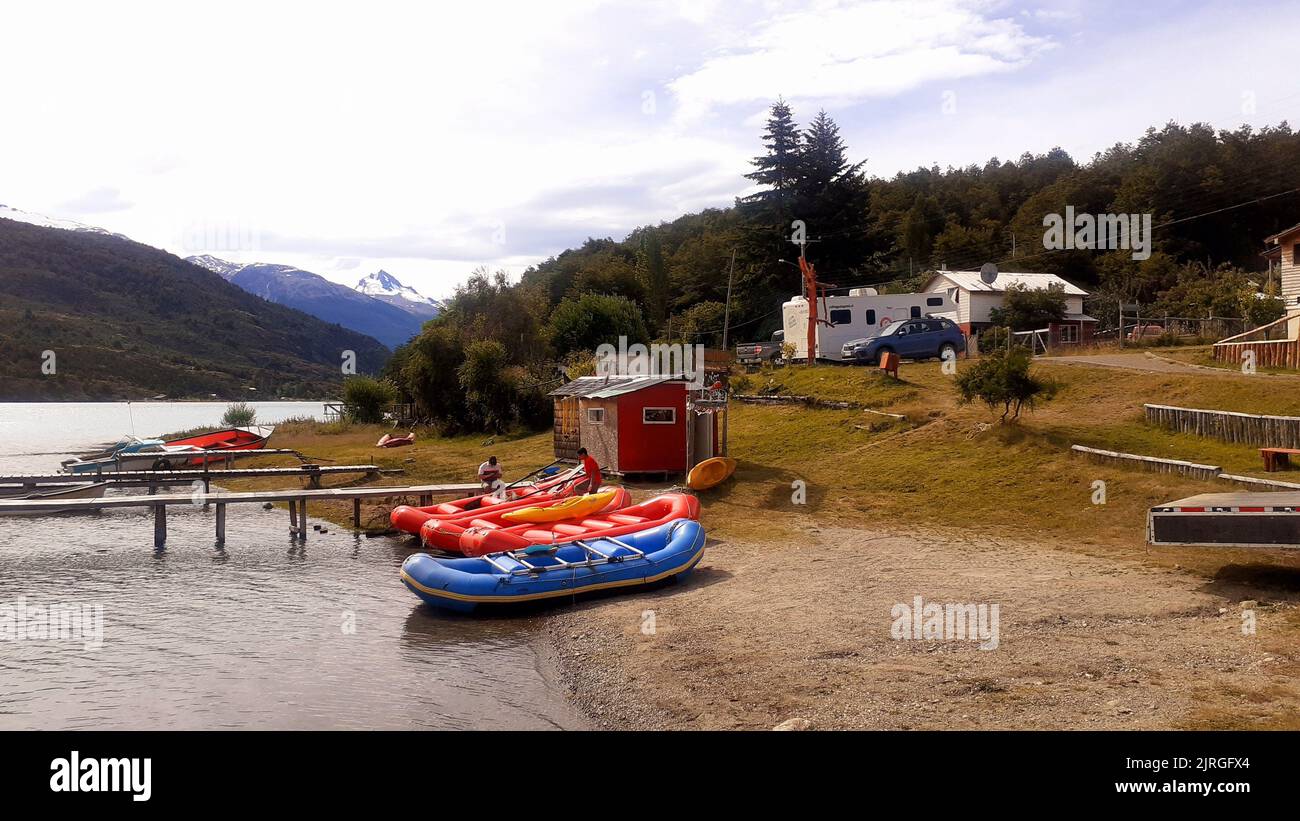 Die aufblasbaren Boote vertäuten an der Küste, umgeben von grüner Vegetation. Puerto Bertrand, Chile. Stockfoto
