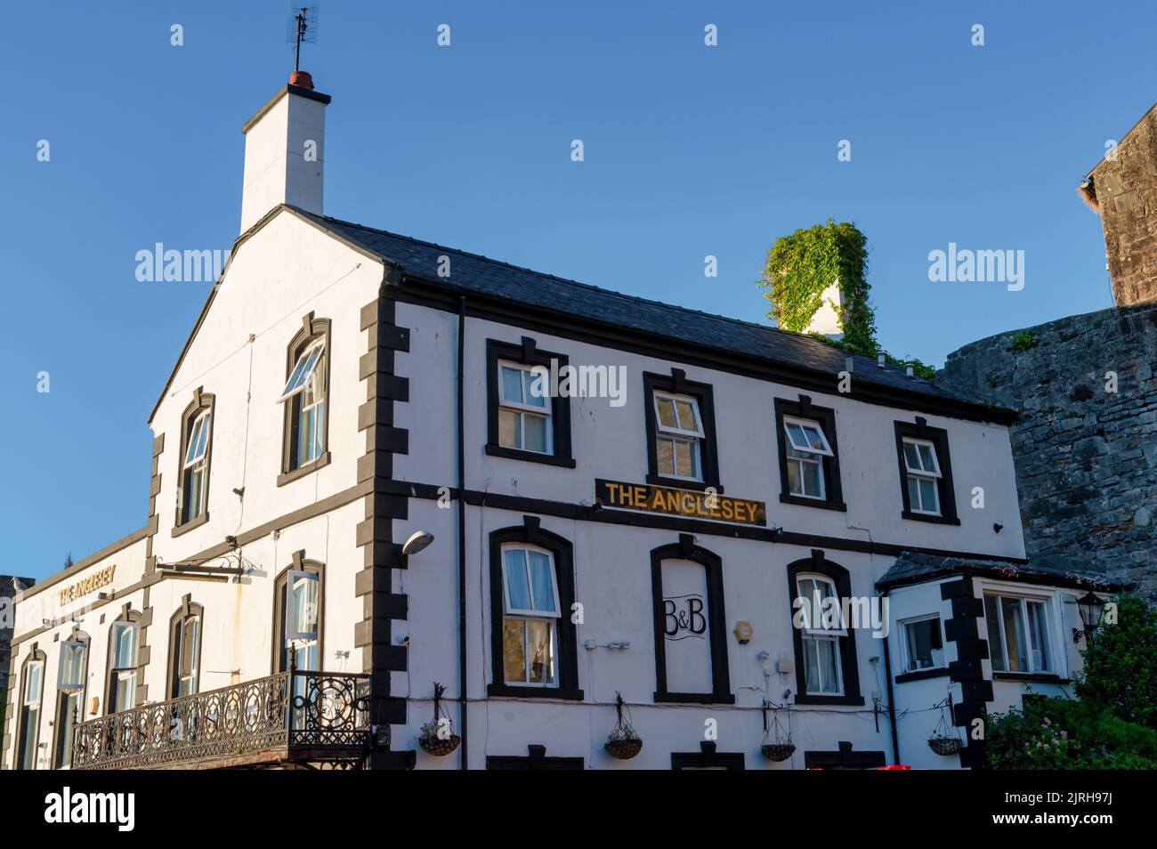 Caernarfon, Großbritannien, 10. Juli 2022: Das Anglesey Pub befindet sich neben der mittelalterlichen Mauer von Caernafon in Wales. Stockfoto