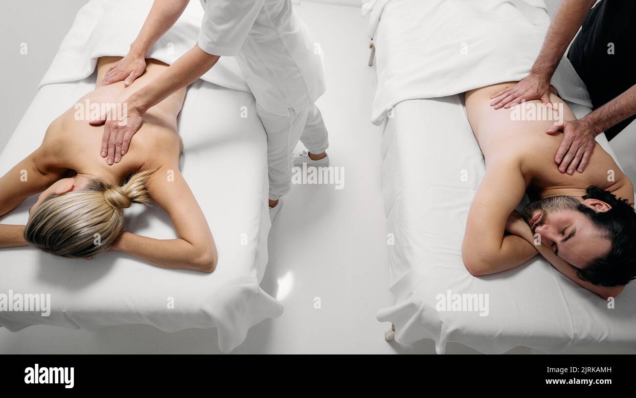 Paarmassage mit Aromaöl, Draufsicht. Schönes Paar verbringt Zeit zusammen und genießt romantische Massagen im Spa Resort Stockfoto
