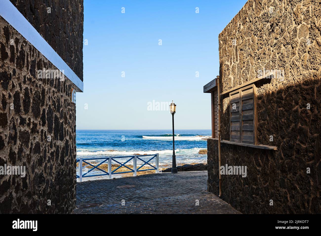 Malerischer Blick auf die gemauerte Häuser an der Küste vor dem endlosen Wellenmeer unter blauem Himmel in Fuerteventura Spanien Stockfoto