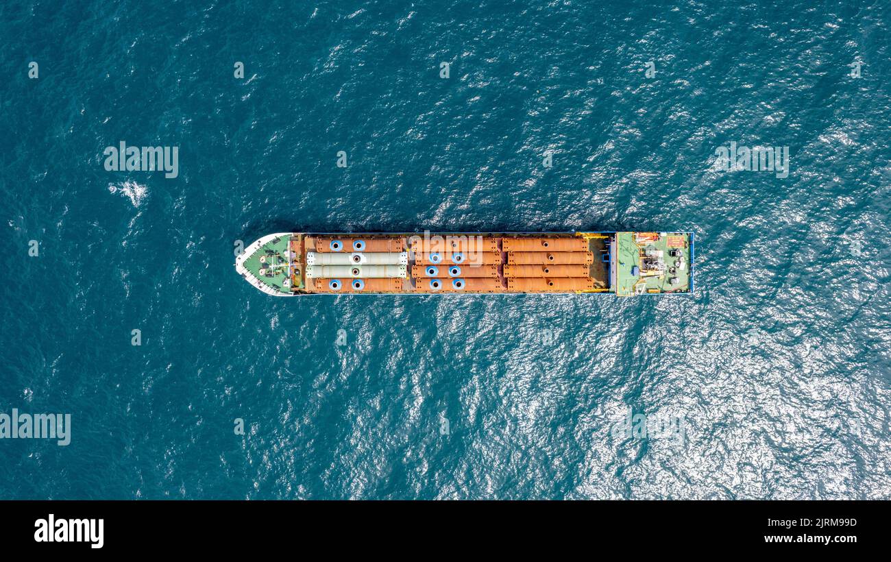 Das Frachtschiff transportiert industrielle Metallrohre auf See. Stockfoto