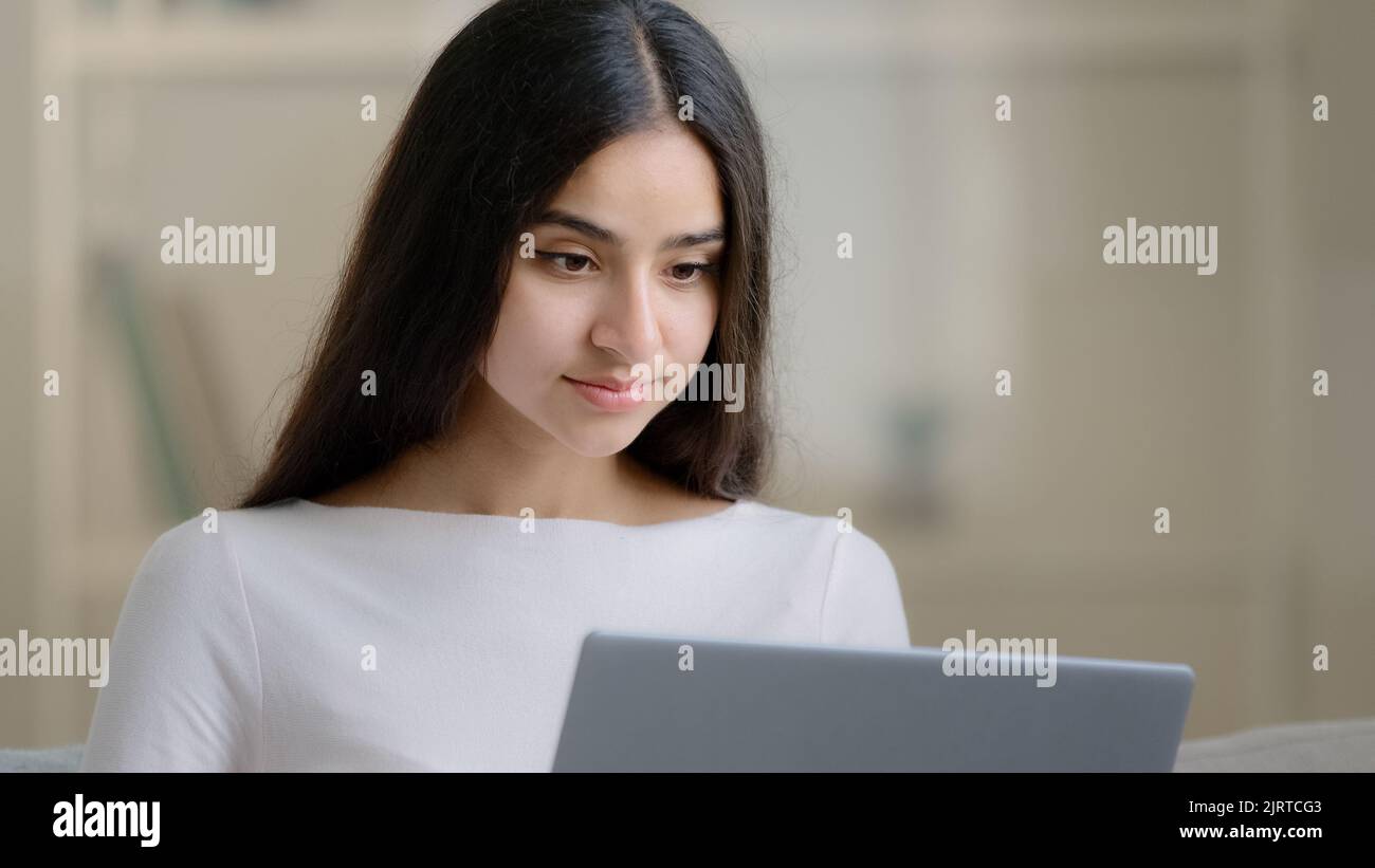 Ruhige konzentrierte junge Student machen Hausaufgaben pädagogische Aufgaben am Computer Online-Studium zu Hause während der Quarantäne. Arabisches Mädchen Frau arbeitet Stockfoto