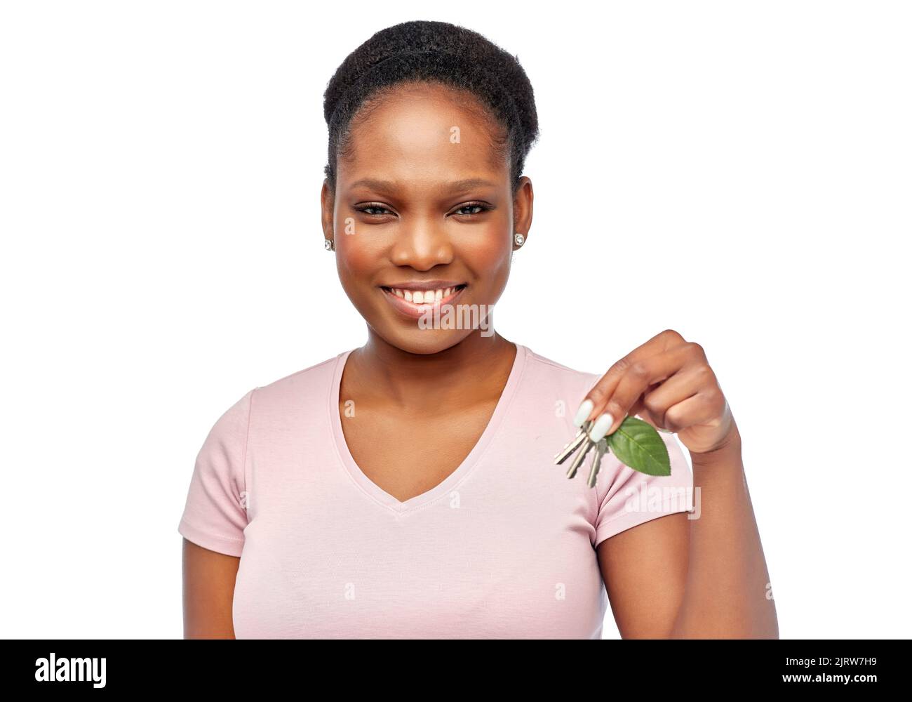 afrikanische Frau mit grünem Blatt und Hausschlüssel Stockfoto