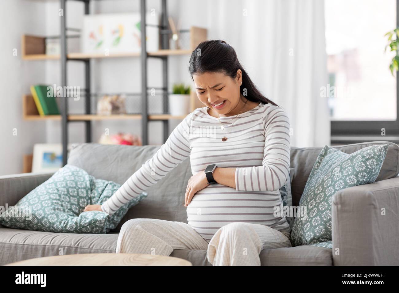 Schwanger Frau mit Wehen Kontraktionen zu Hause Stockfoto