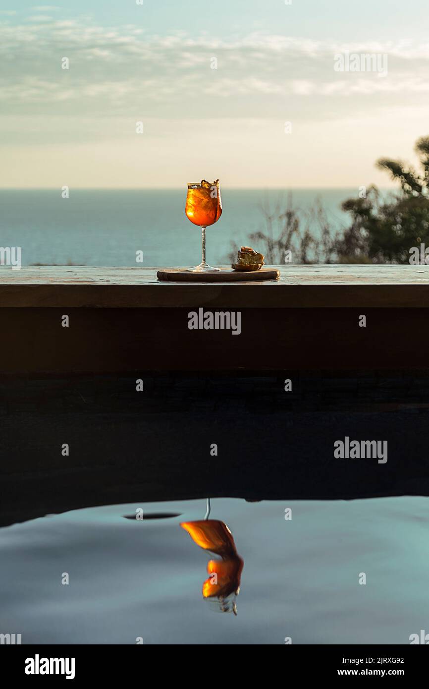 Orangencocktail mit einer Tapa am Pool. Sommerliche Stimmung. Frisch, natürlich. Elegant, stilvoll Stockfoto