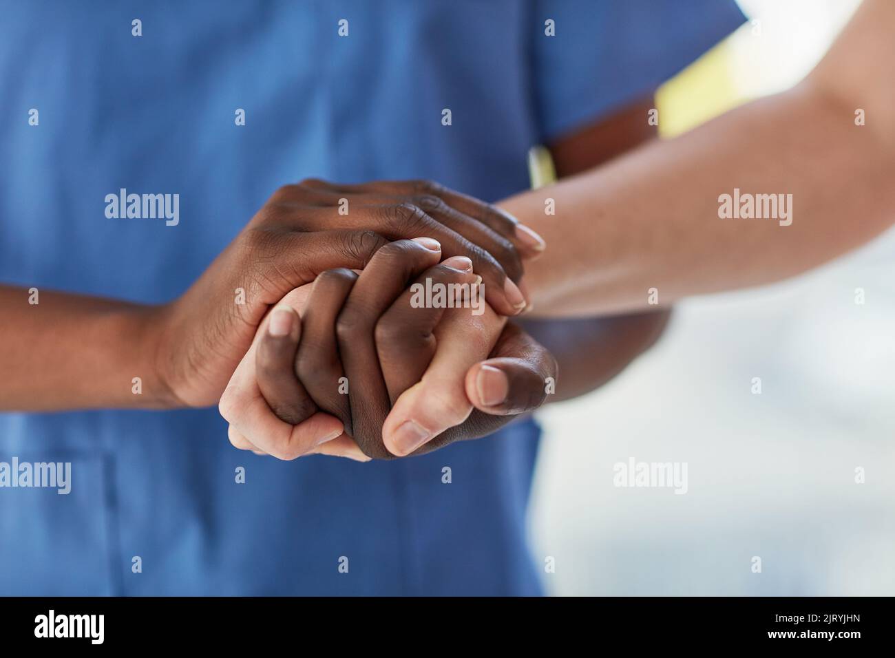 Einem Patienten die Pflege und den Komfort bieten, den er braucht. Nahaufnahme eines Arztes, der die Hand des Patienten bequem in der Hand hält. Stockfoto