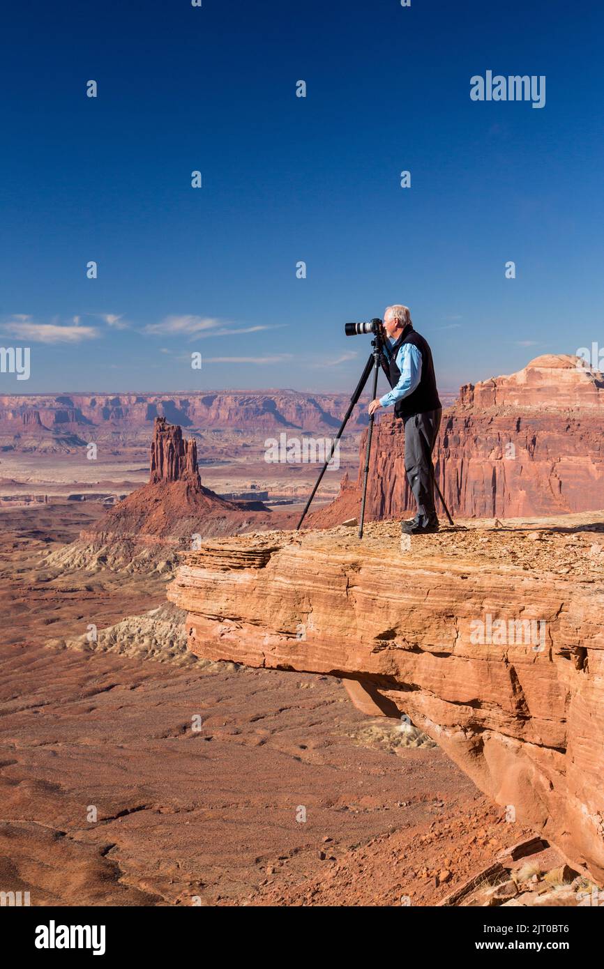Ein Landschaftsfotograf, der ein Bild von einem überhängenden Felsen im Canyonlands National Park in der Nähe von Moab, Utah, macht. Stockfoto