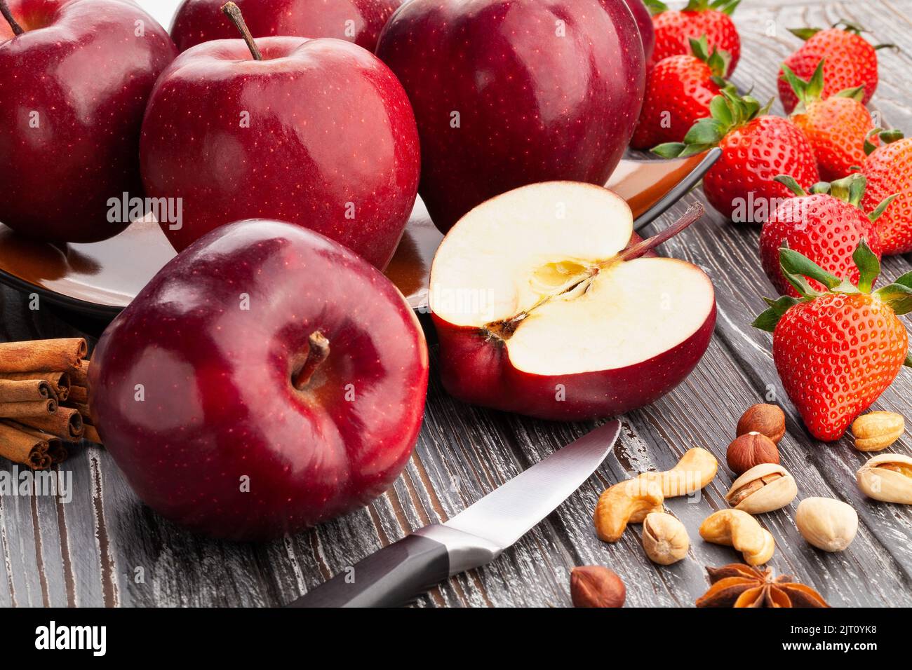 In Scheiben geschnittener roter köstlicher Apfel auf Holzhintergrund Stockfoto