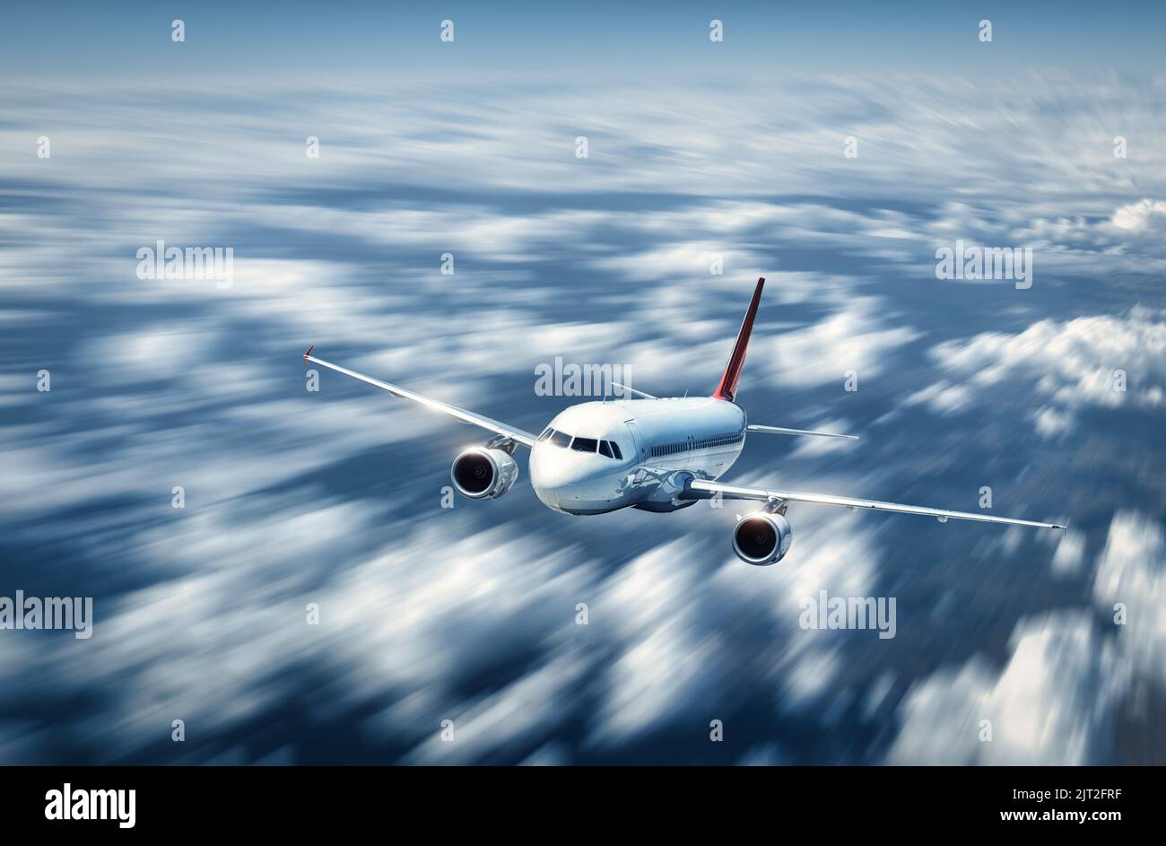 Das Flugzeug fliegt im Sommer über den niedrigen Wolken Stockfoto