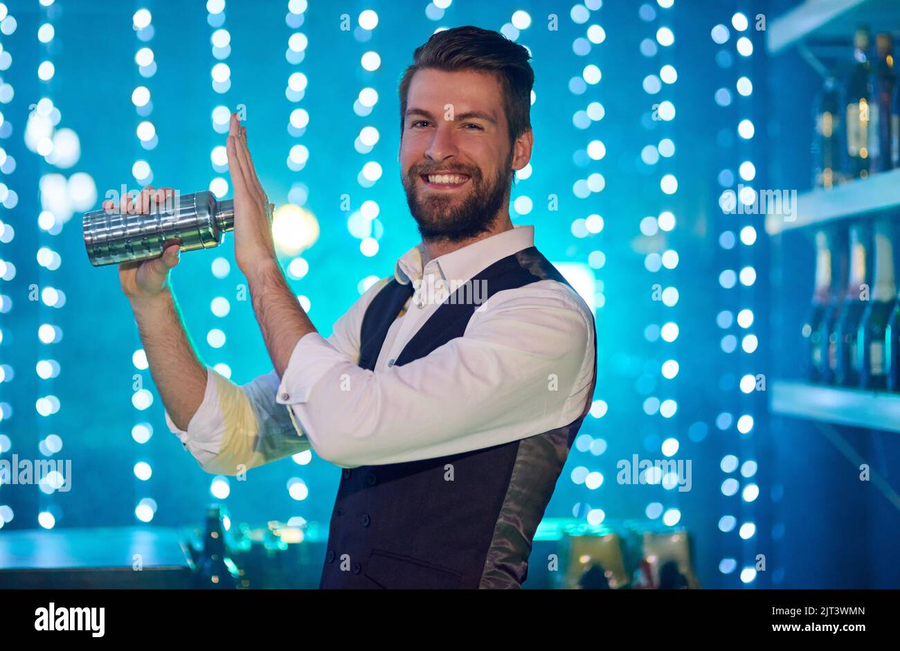 Zeit, die Dinge hier oben zu schütteln. Porträt eines hübschen jungen Barkeepers, der in einem Nachtclub Getränke mischt. Stockfoto