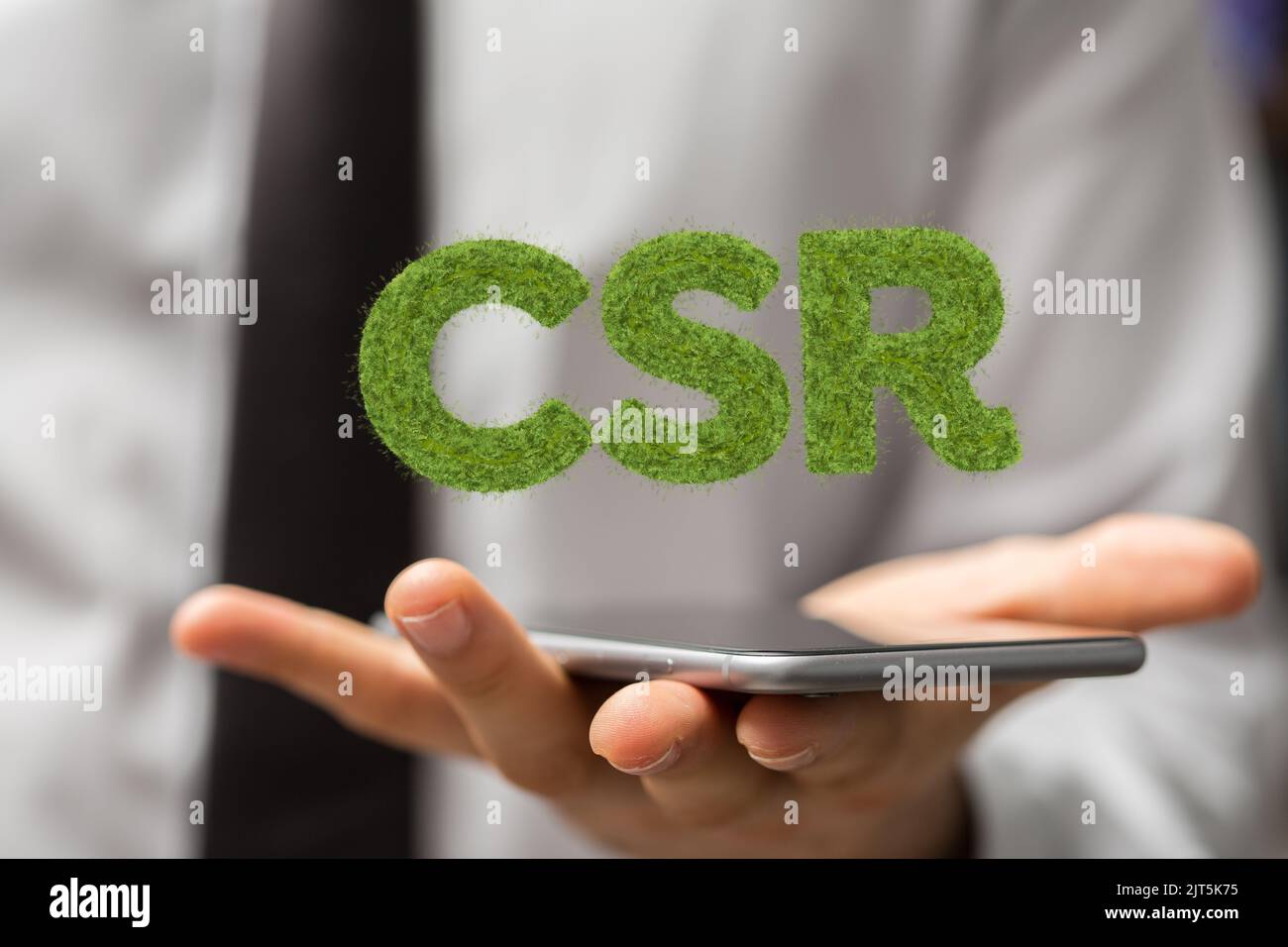 Ein 3D gerenderter CSR-Text, der in der mans-Hand schwebt Stockfoto