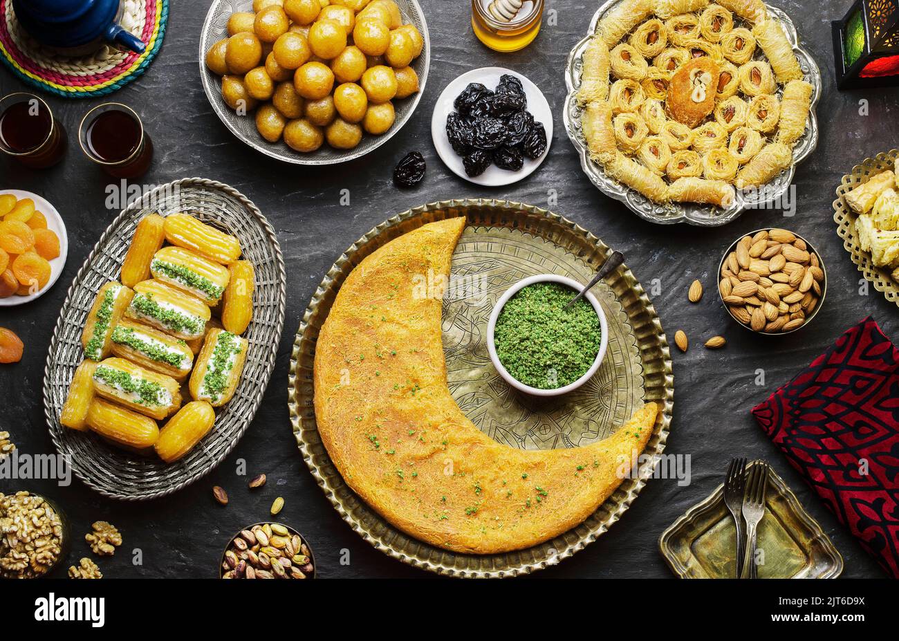 Arabische Küche: Desserts aus dem Nahen Osten. Köstliche Sammlung von traditionellen Ramadan Desserts. Serviert mit leckeren Nüssen, getrockneten Früchten und Honigsirup. Stockfoto