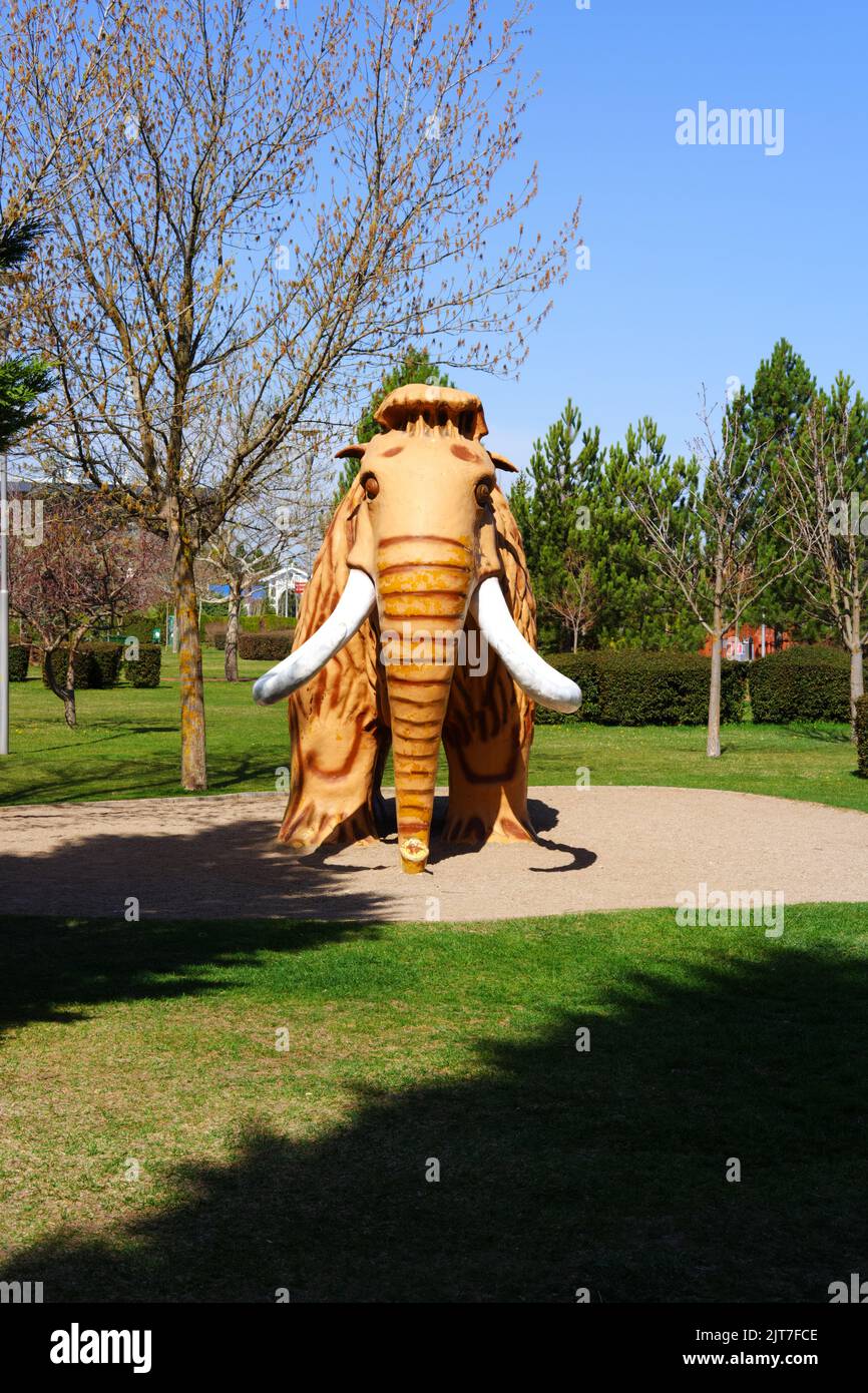 Mammutspielzeug im Park mit grünen Blättern und Bäumen Stockfoto