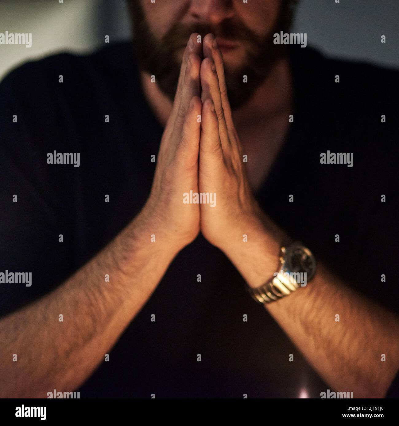 Wir beten hart um Erlösung. Nahaufnahme eines Mannes, dessen Hände im Gebet zusammengeklemmt sind. Stockfoto