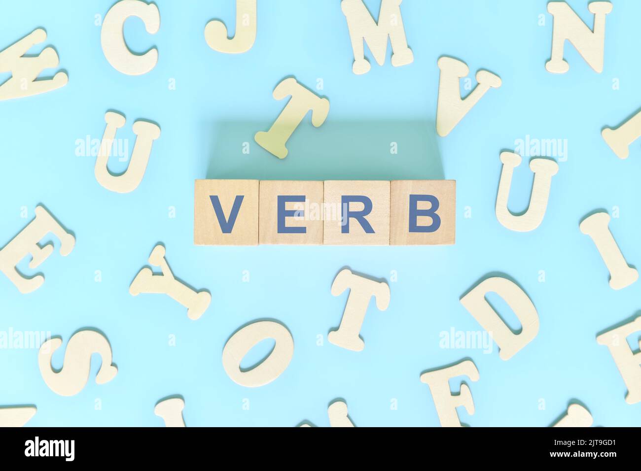 Verb-Konzept in englischer Grammatik und Unterrichtsstunde. Holzblöcke Typografie Wort flach lag auf blauem Hintergrund. Stockfoto