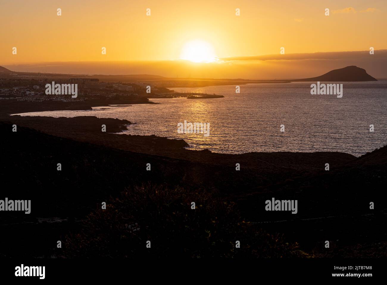 Roter Berg, Montaña Roja in Silhouette bei Sonnenaufgang. Morgendämmerung an der Ostküste von Teneriffa, Kanarische Inseln, Spanien Stockfoto