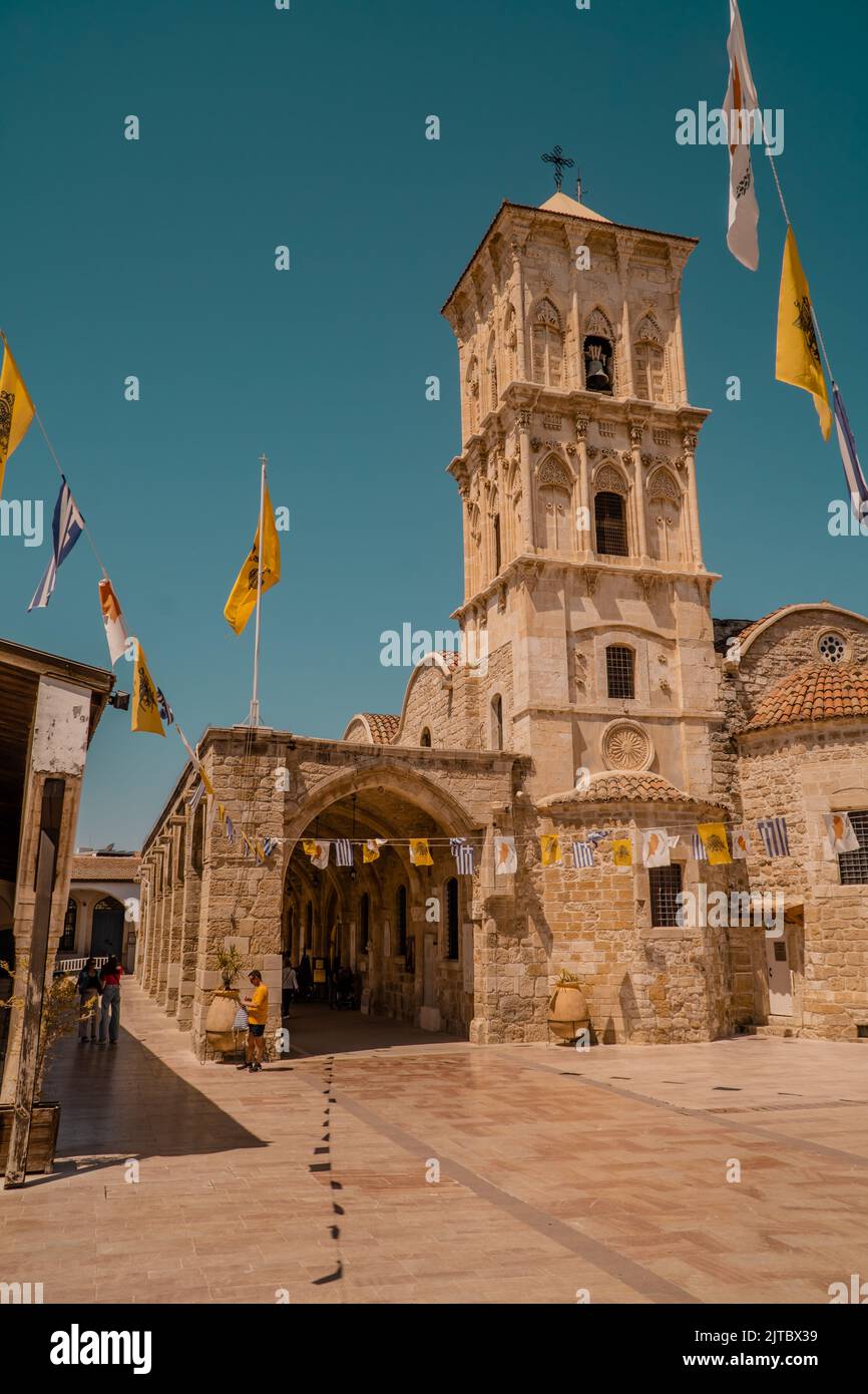 Eine vertikale Aufnahme der Lazarus Kirche in Zypern mit griechischer und Lazarus-Flagge an einem sonnigen Tag Stockfoto