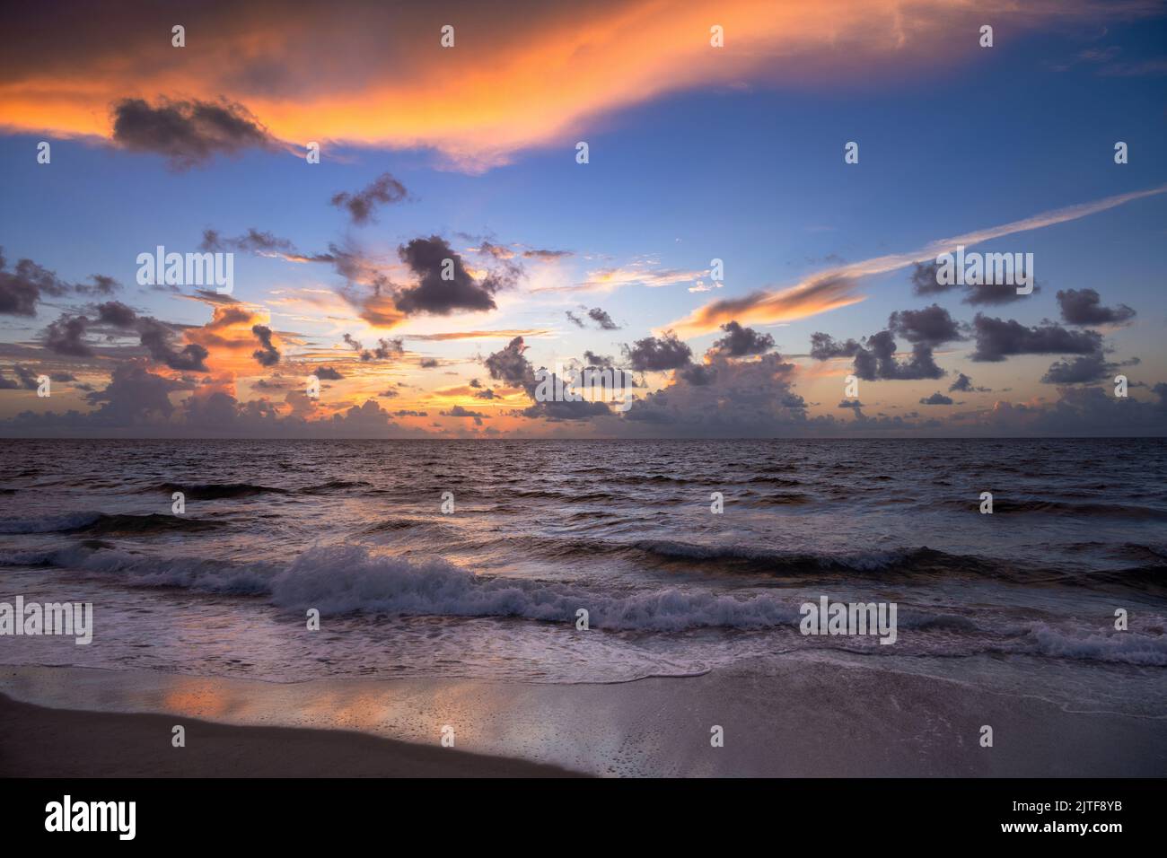 Dramatischer Sonnenaufgang über dem Meer und dem Strand Stockfoto