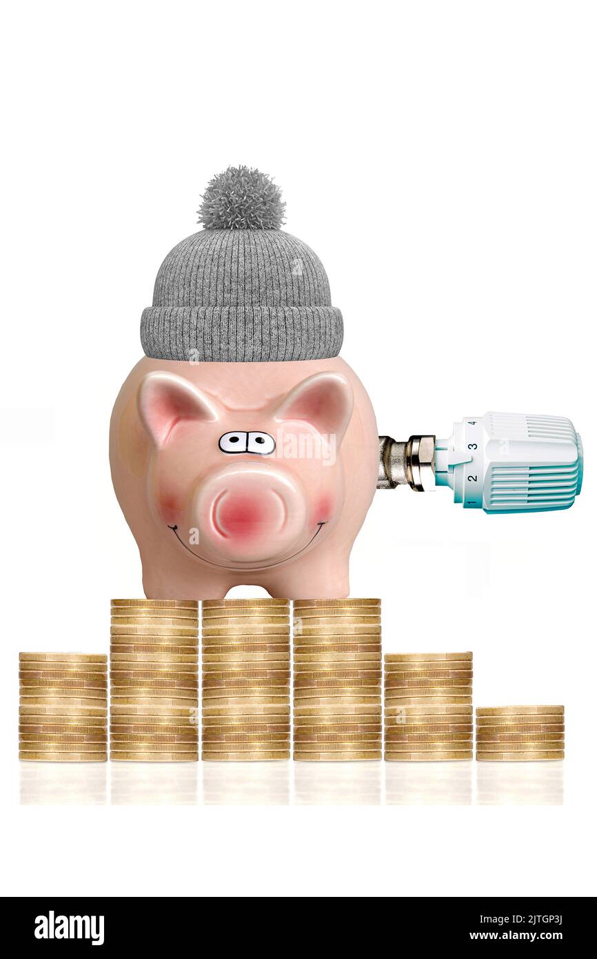 Münzstapel und Sparschwein mit Bommel-Hut und Thermostat-Ventil Stockfoto