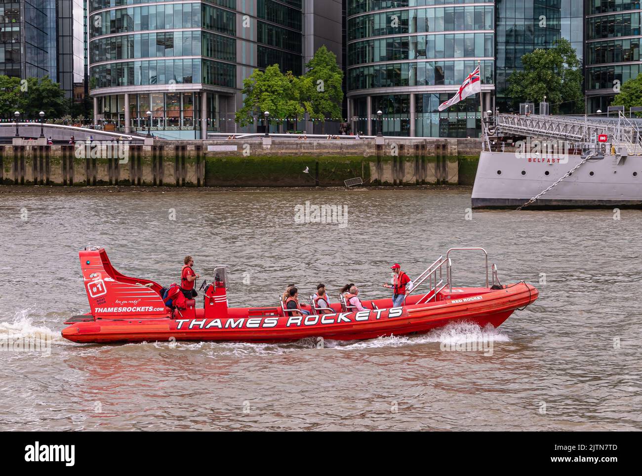 London, England, Großbritannien - 6. Juli 2022: An der Themse. Nahaufnahme eines roten Touristenmotorbootes, das von Thames Rockets betrieben wird. Teil von HMS Belfast Schiff und Queens Stockfoto