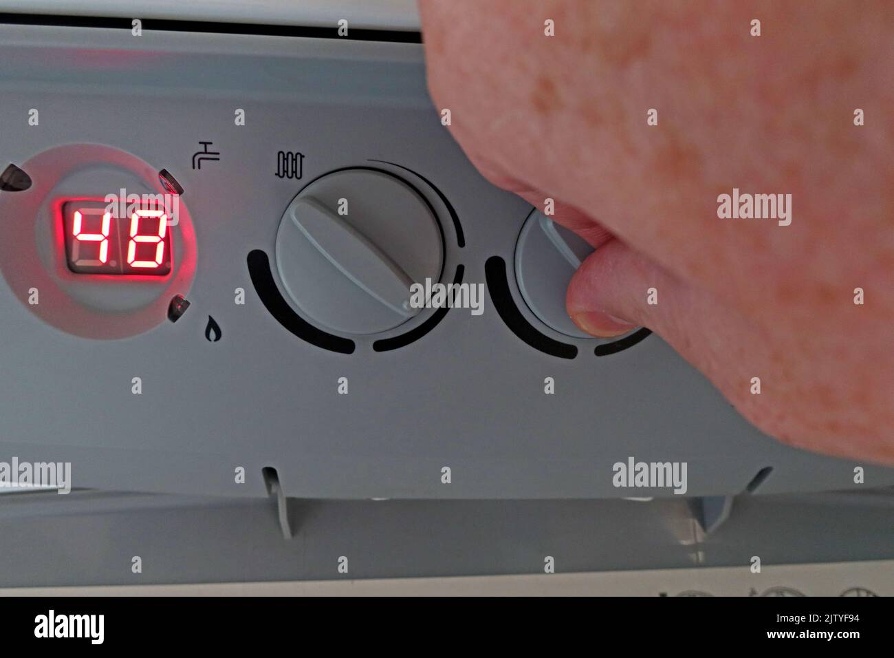 Manuelles Ändern der Warmwassertemperatur zur Reduzierung der Kraftstoffrechnung, Senkung der Brennwerttemperatur des zentralen Heizkessels für Warmwasser - Baxi Platinum Stockfoto
