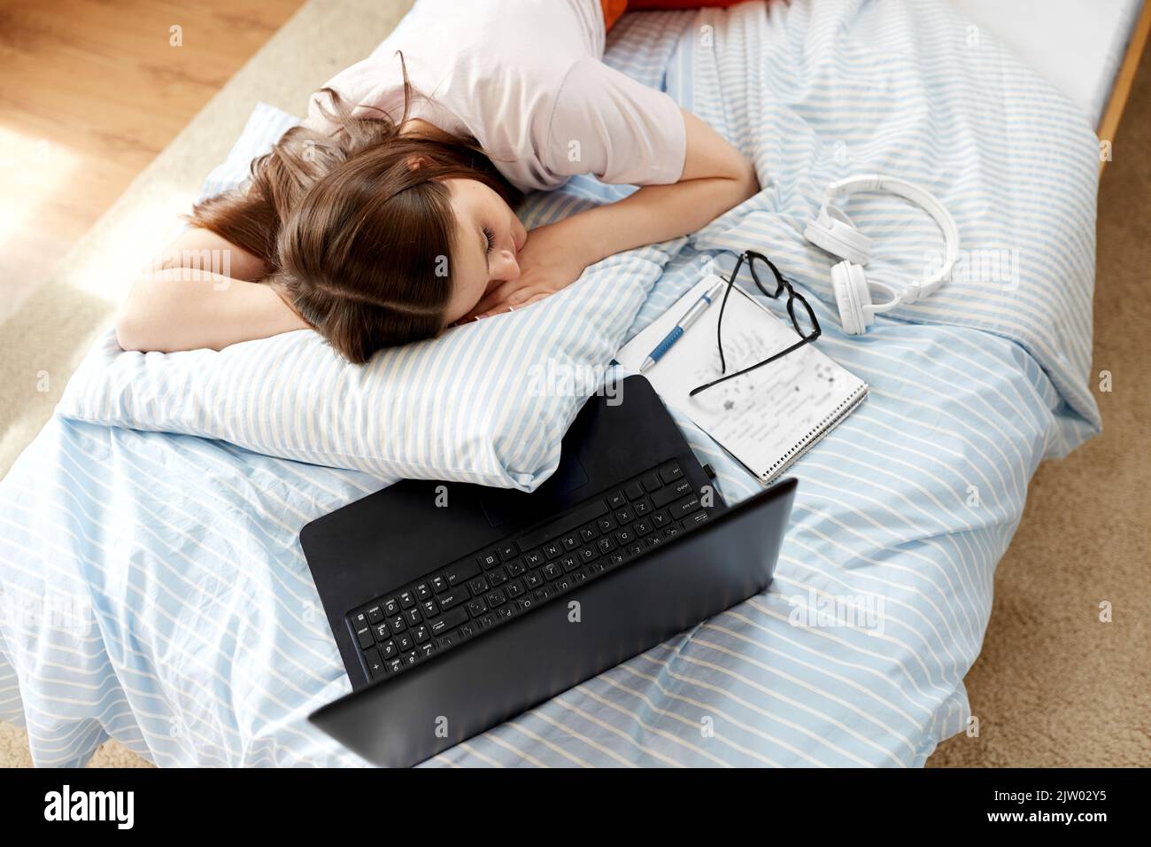 Müde Student Mädchen mit Laptop schlafen zu Hause Stockfoto