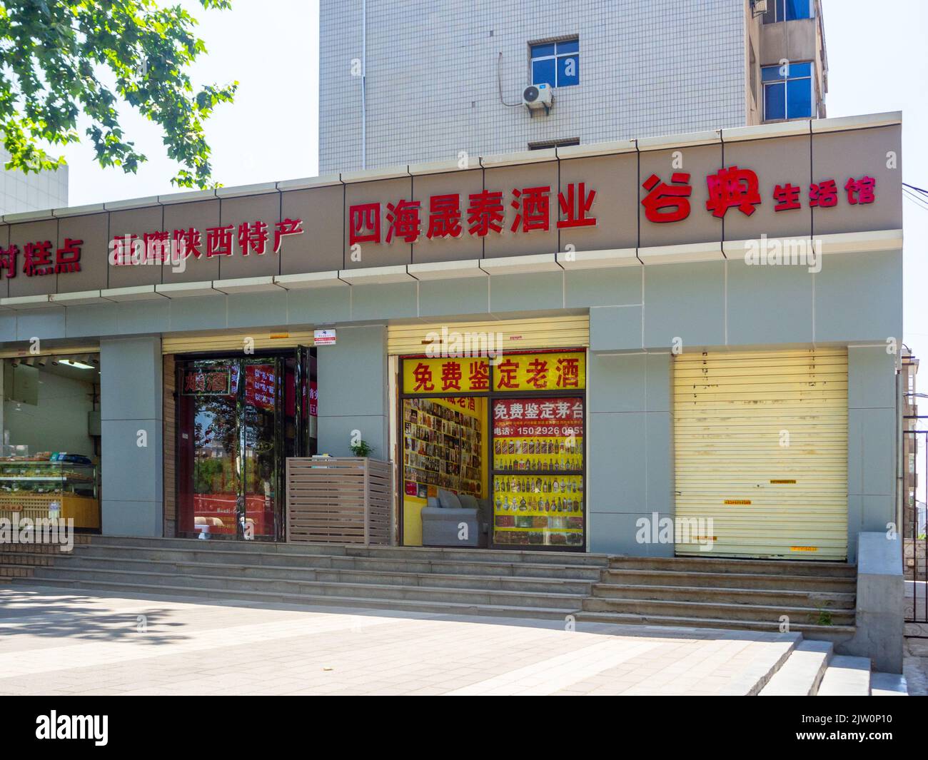 Eintritt für kleine Unternehmen mit Schilder in chinesischem Text. Stockfoto