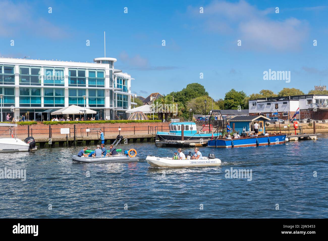 Menschen, die Bootsfahrten auf dem River Stour Unternehmen, vorbei am Captain's Club Hotel & Spa in Christchurch, Dorset, England, Großbritannien Stockfoto