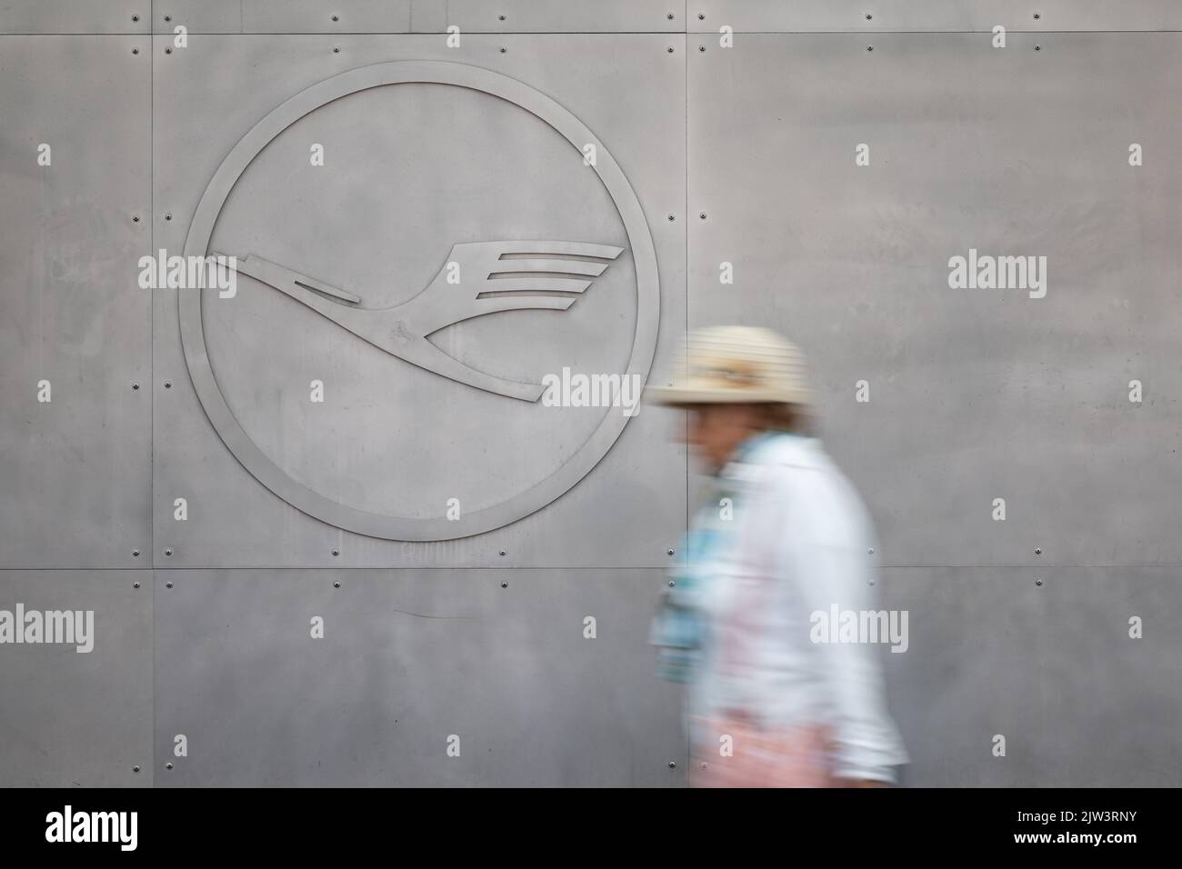03. September 2022, Hessen, Frankfurt/Main: Eine Frau geht am Lufthansa-Logo vorbei. Nach dem gestrigen Streik der Lufthansa-Piloten läuft der Flugbetrieb weitgehend normal. Foto: Hannes P. Albert/dpa Stockfoto