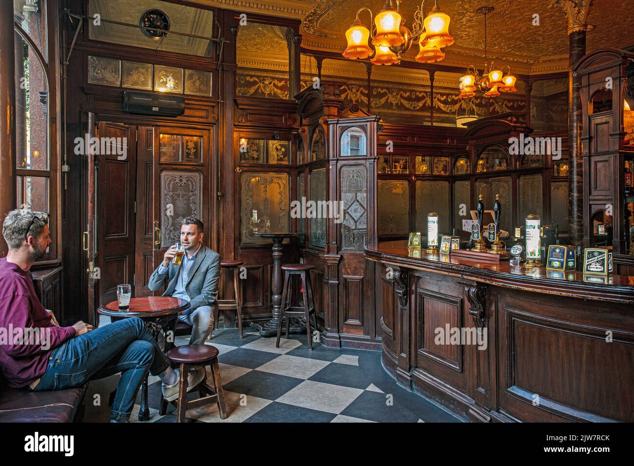 Massenschließungen von Pubs aufgrund steigender Stromrechnungen. Zwei Männer trinken Bier im Princess Louise Pub, London, Großbritannien. Stockfoto