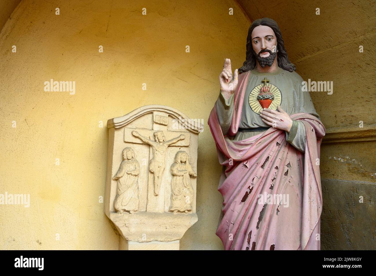 Die Statue des heiligsten Herzens Jesu – ein Altar an der Ecke einer Straße. Bertrange, Luxemburg. Stockfoto