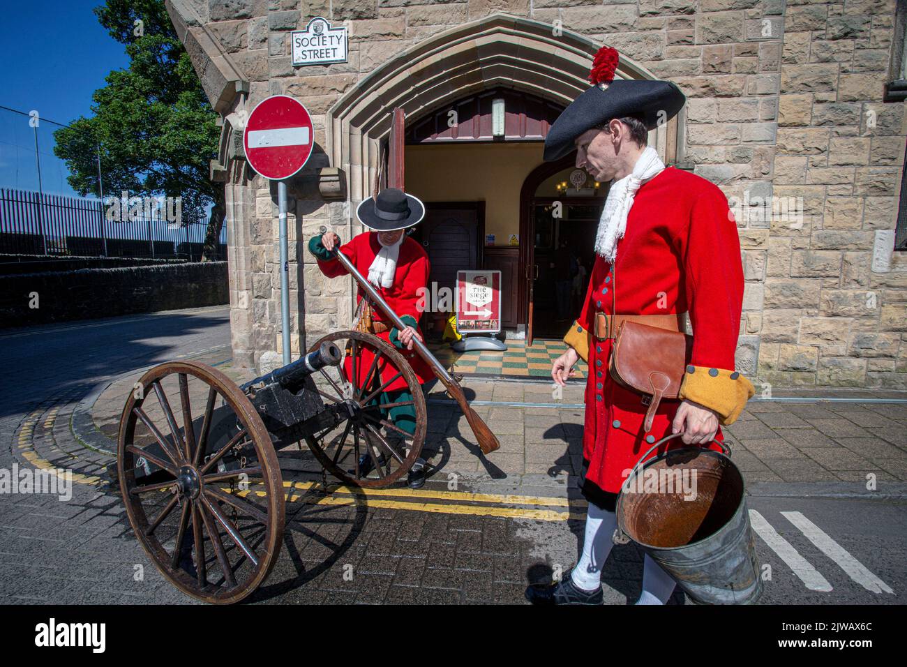 Lehrlingsjungen mit Kanonen, die die historische Belagerung von Derry in den Stadtmauern von Londonderry, Derry, Nordirland, nachstellen. Stockfoto